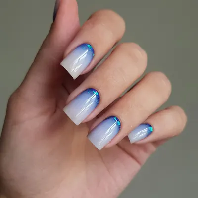 Square gel nails fading from white to blue at the tips